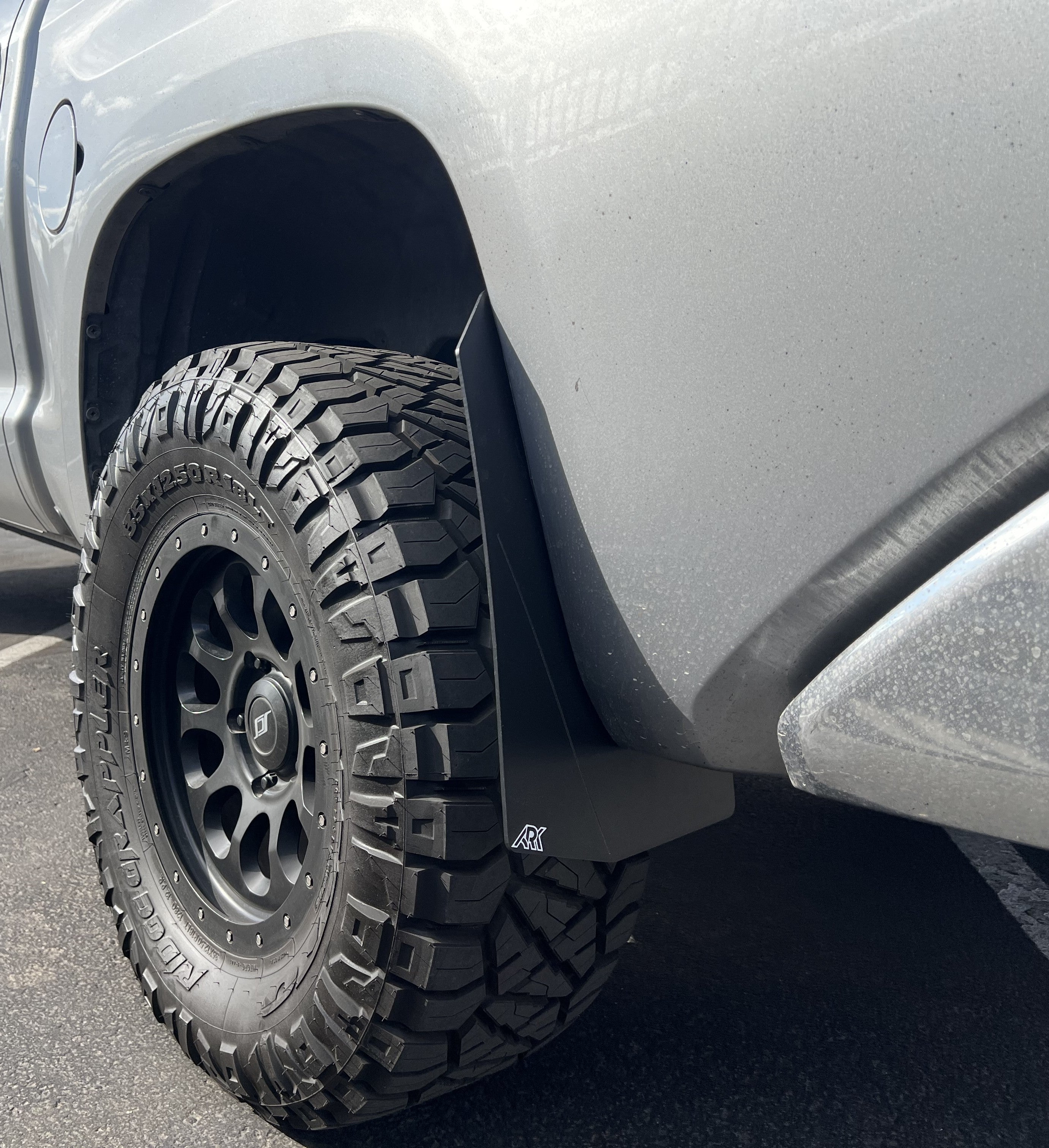 2007-2021 Toyota Tundra TriXpoly Mid Mudflaps installed on a truck with rugged tires, showcasing durability and off-road capability.