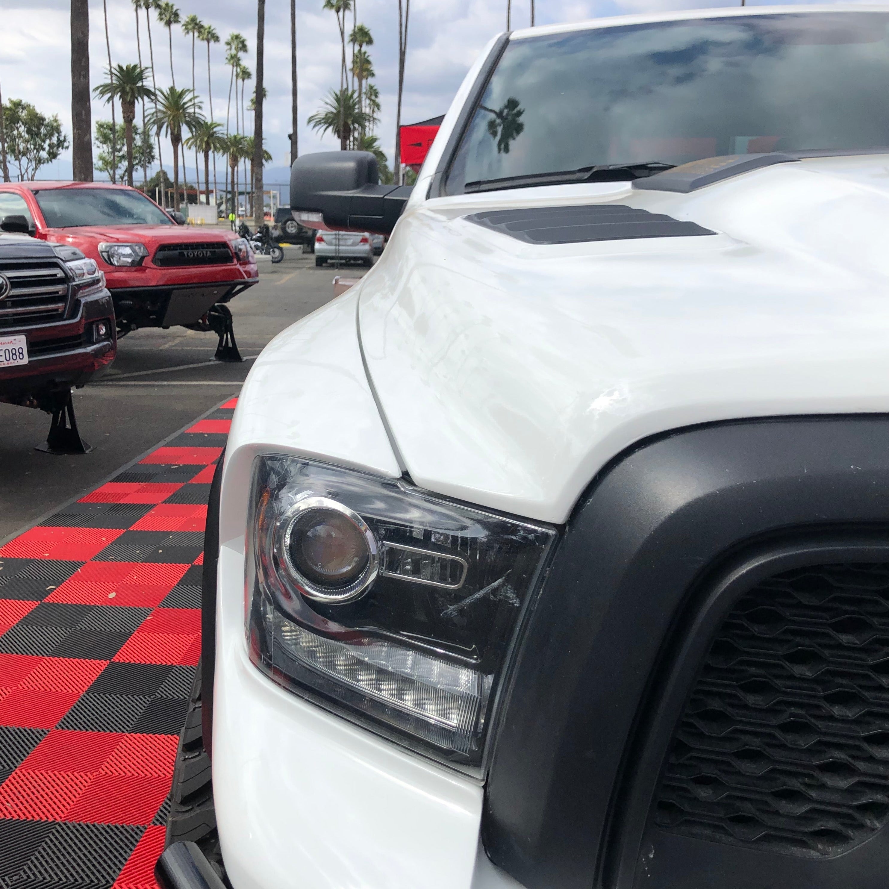 2009-2018 Dodge Ram TRX Kit displayed on a white truck with a close-up of the front headlight and grille.