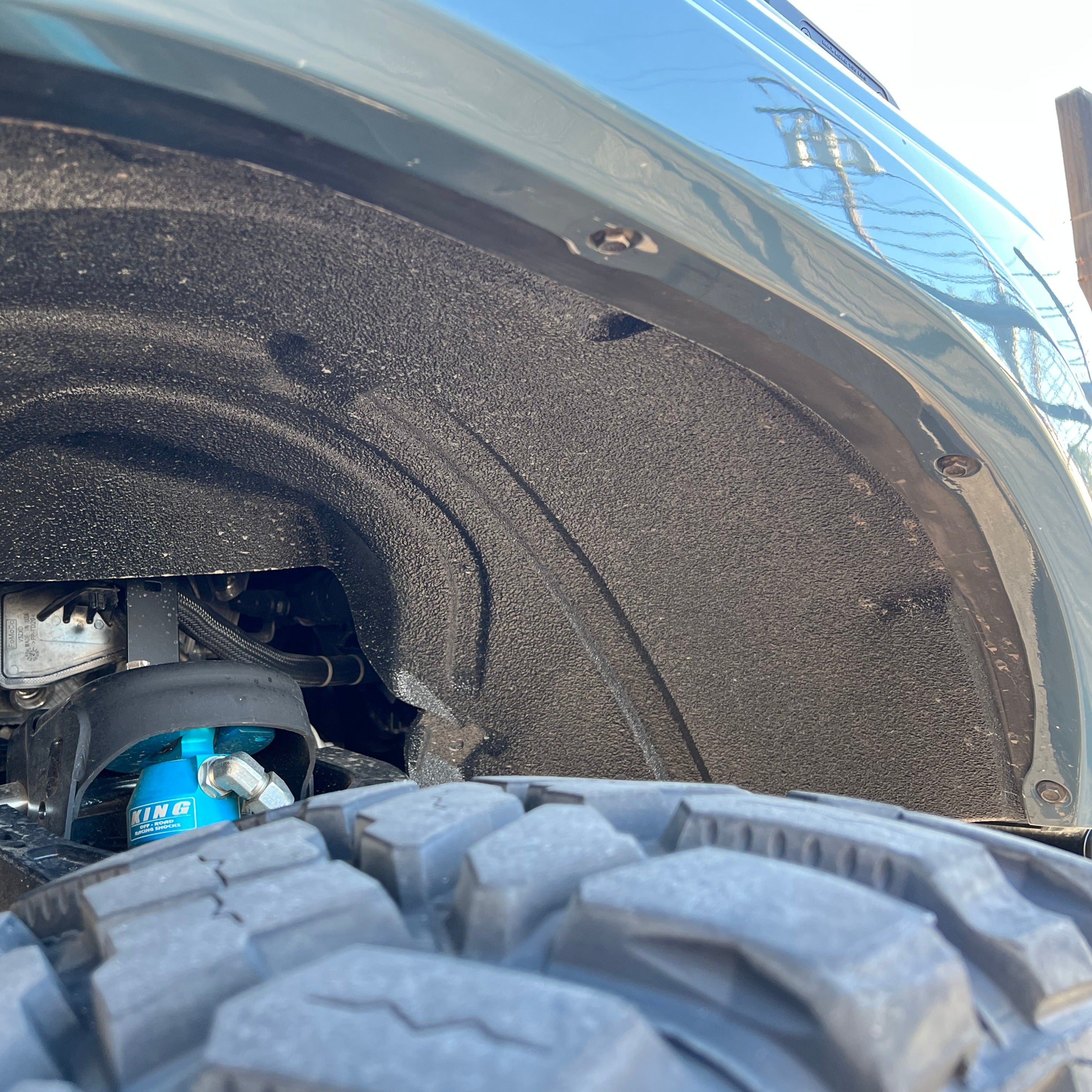 Close-up of a 2021-2025 Ford Bronco fender showcasing the inner wheel well and tire clearance for offroad performance.