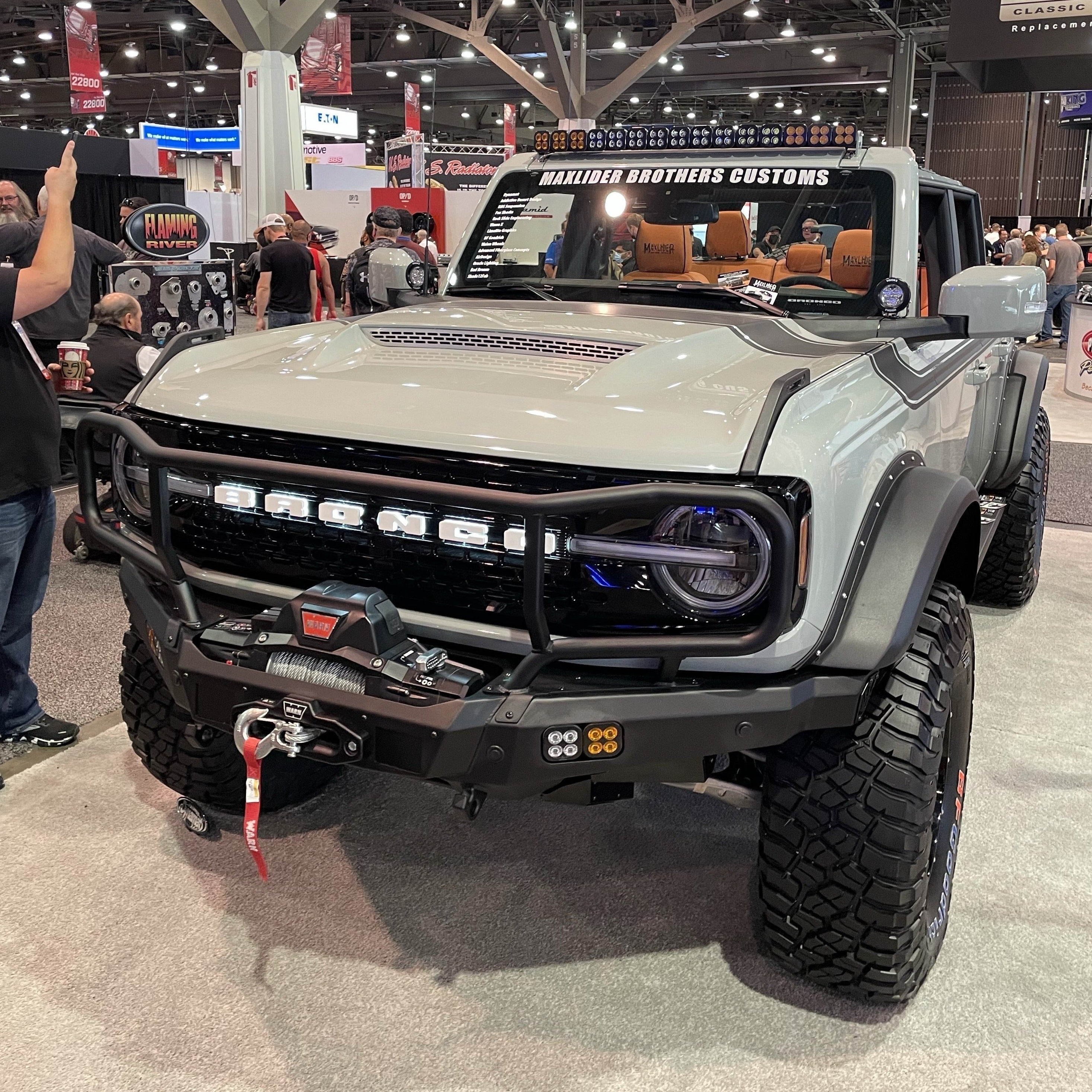 2021-2025 Ford Bronco with a Ram Air Hood and offroad accessories on display at an automotive event.