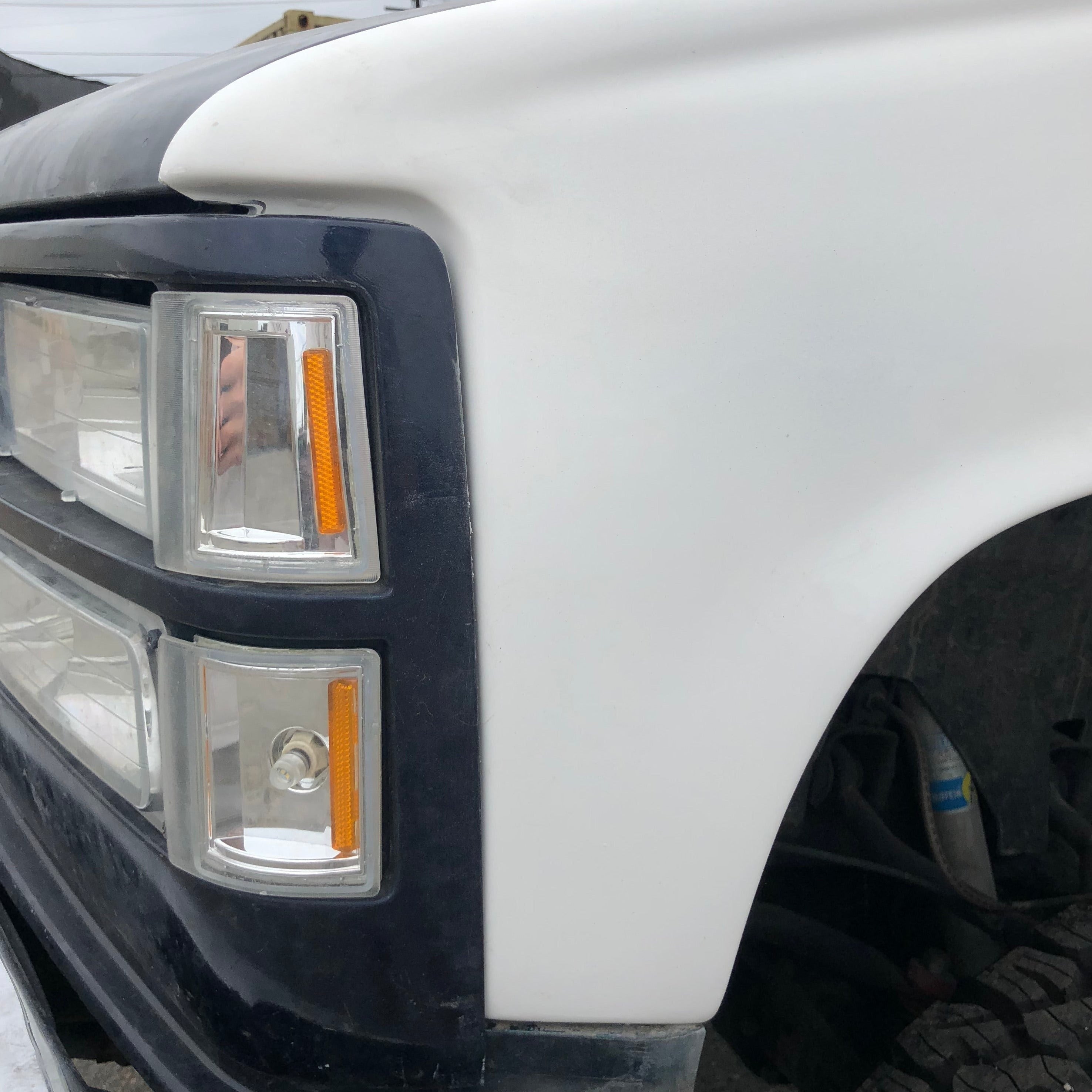 1988-1998 Chevrolet Silverado fenders showcasing a clean, white finish and integrated turn signal lights.