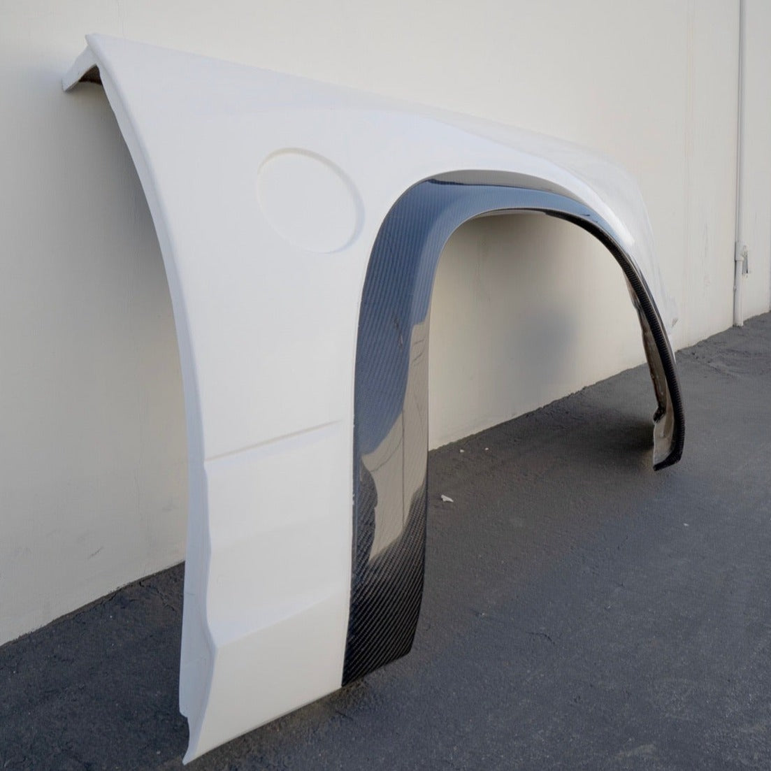 2009-2018 Dodge Ram TRX Kit fender with a sleek white finish and carbon fiber accents, designed for enhanced performance.