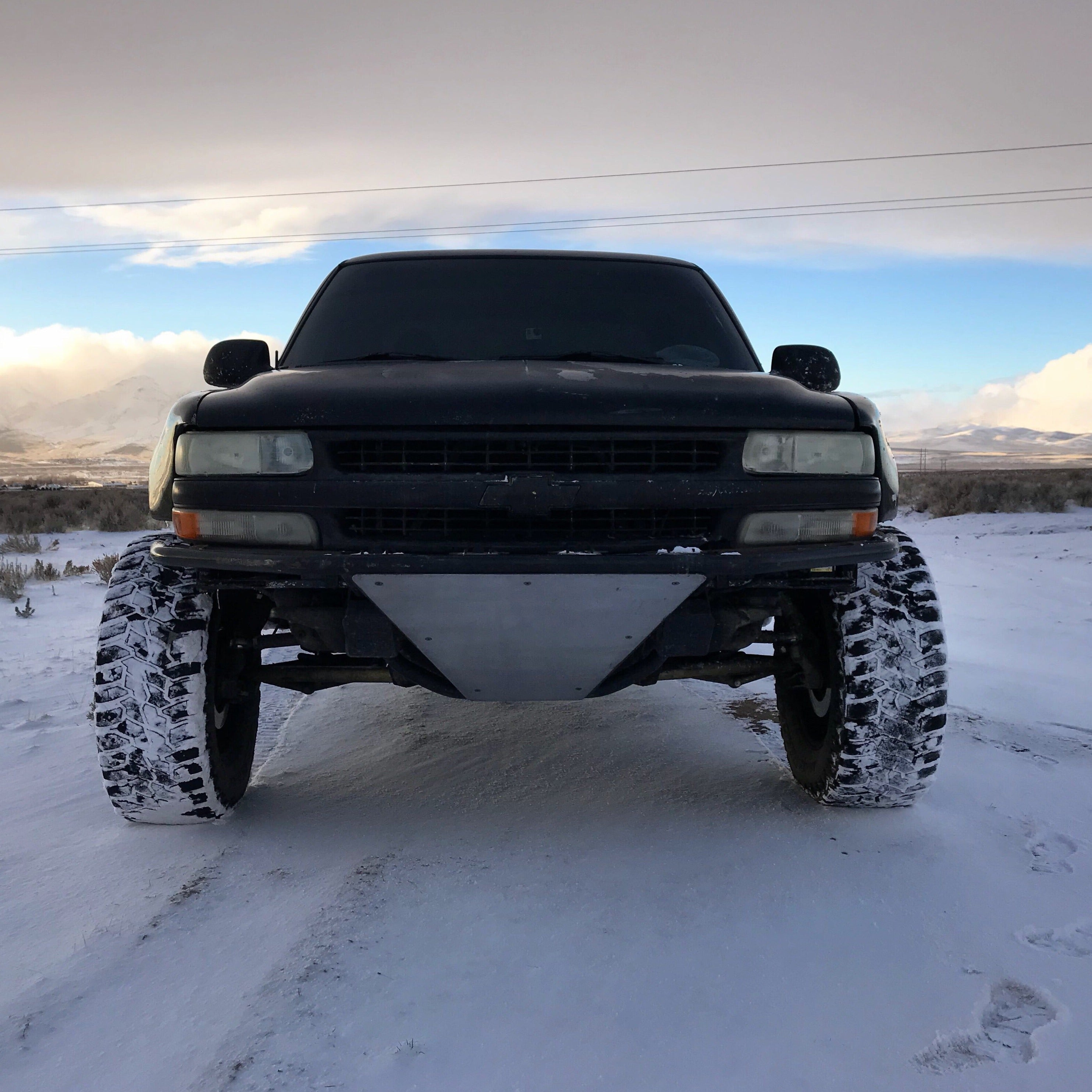 1999-2002 Chevrolet Silverado fenders on a modified truck in a snowy landscape, showcasing offroad capabilities.
