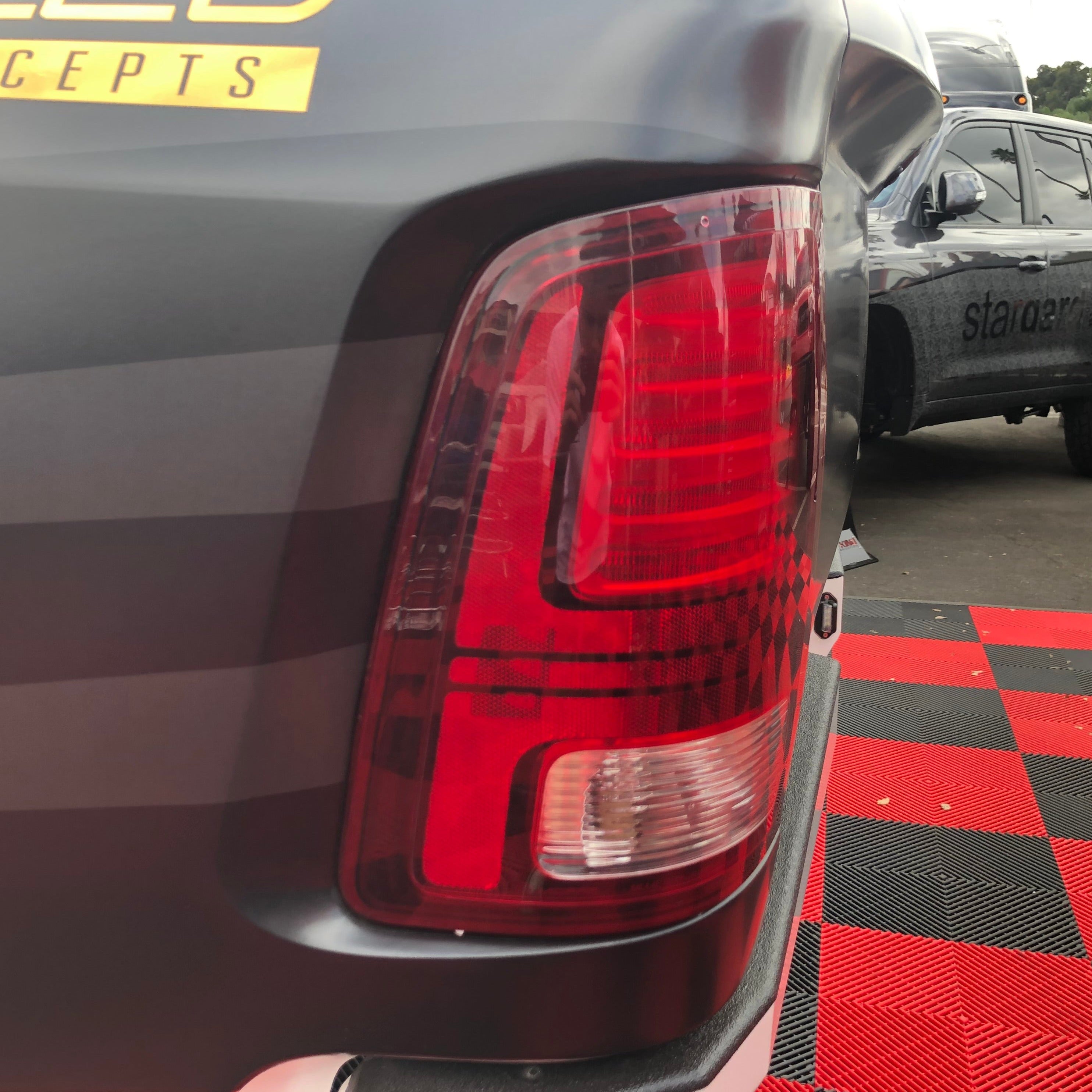 Close-up of a 2009-2018 Dodge Ram TRX tail light, showcasing its sleek design and vibrant red lens.