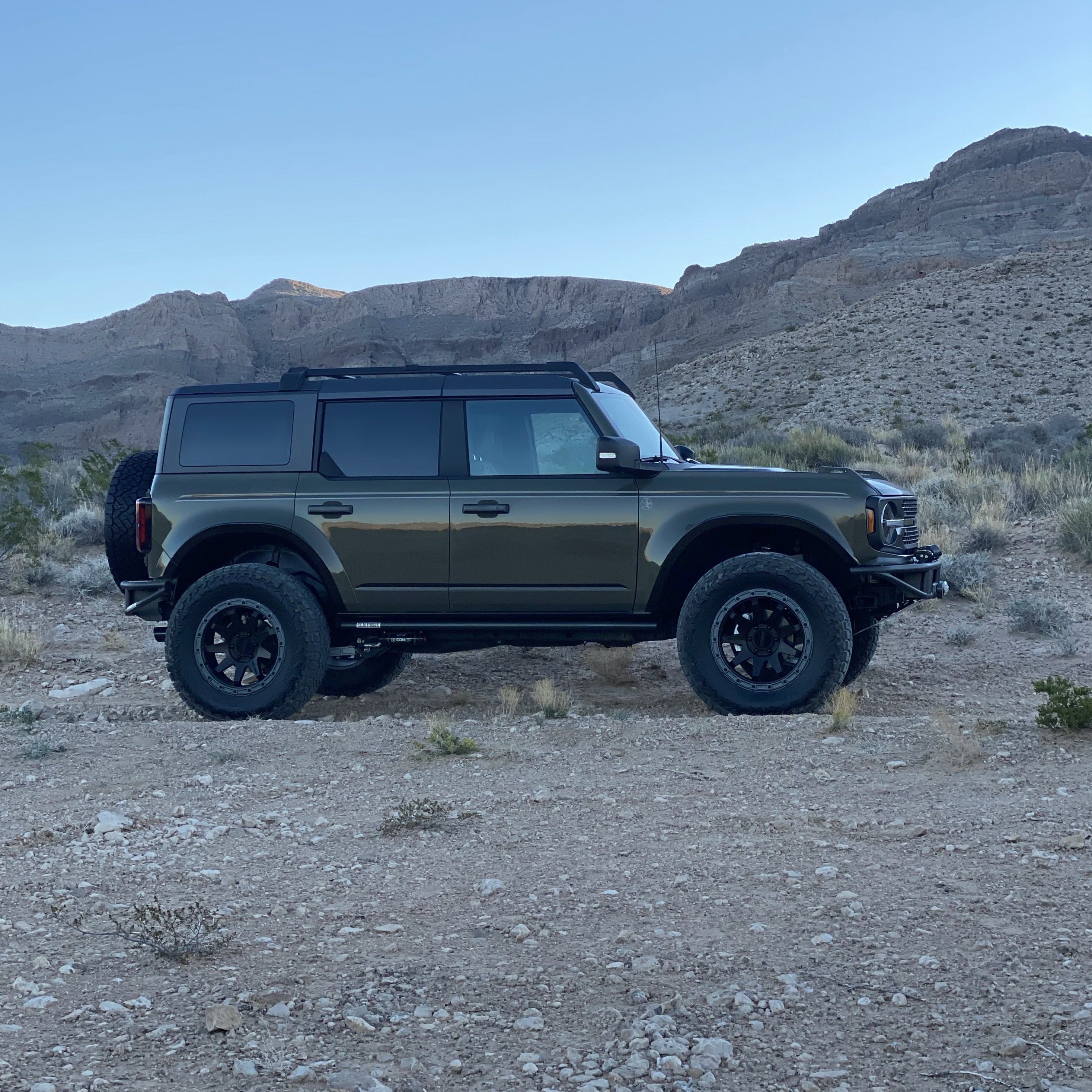 2021-2025 Ford Bronco 4-Door Rear Quarter Kit showcased on a modified Bronco in a desert landscape.