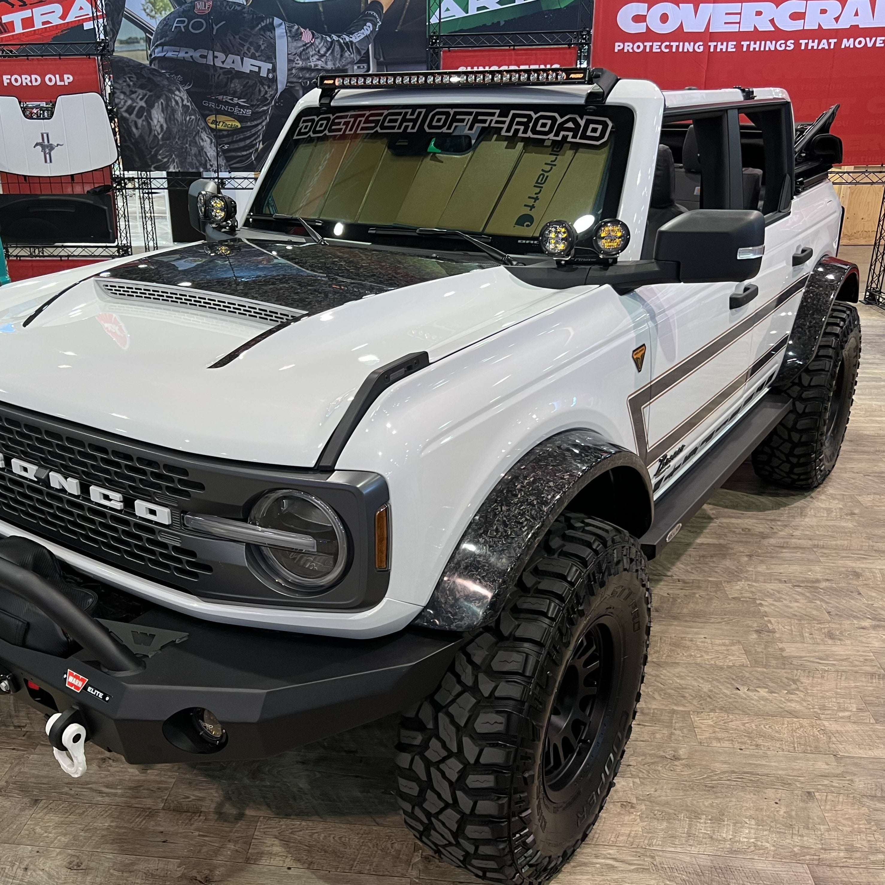 2021-2025 Ford Bronco with Sasquatch flares showcasing rugged design and off-road capability in a showroom setting.