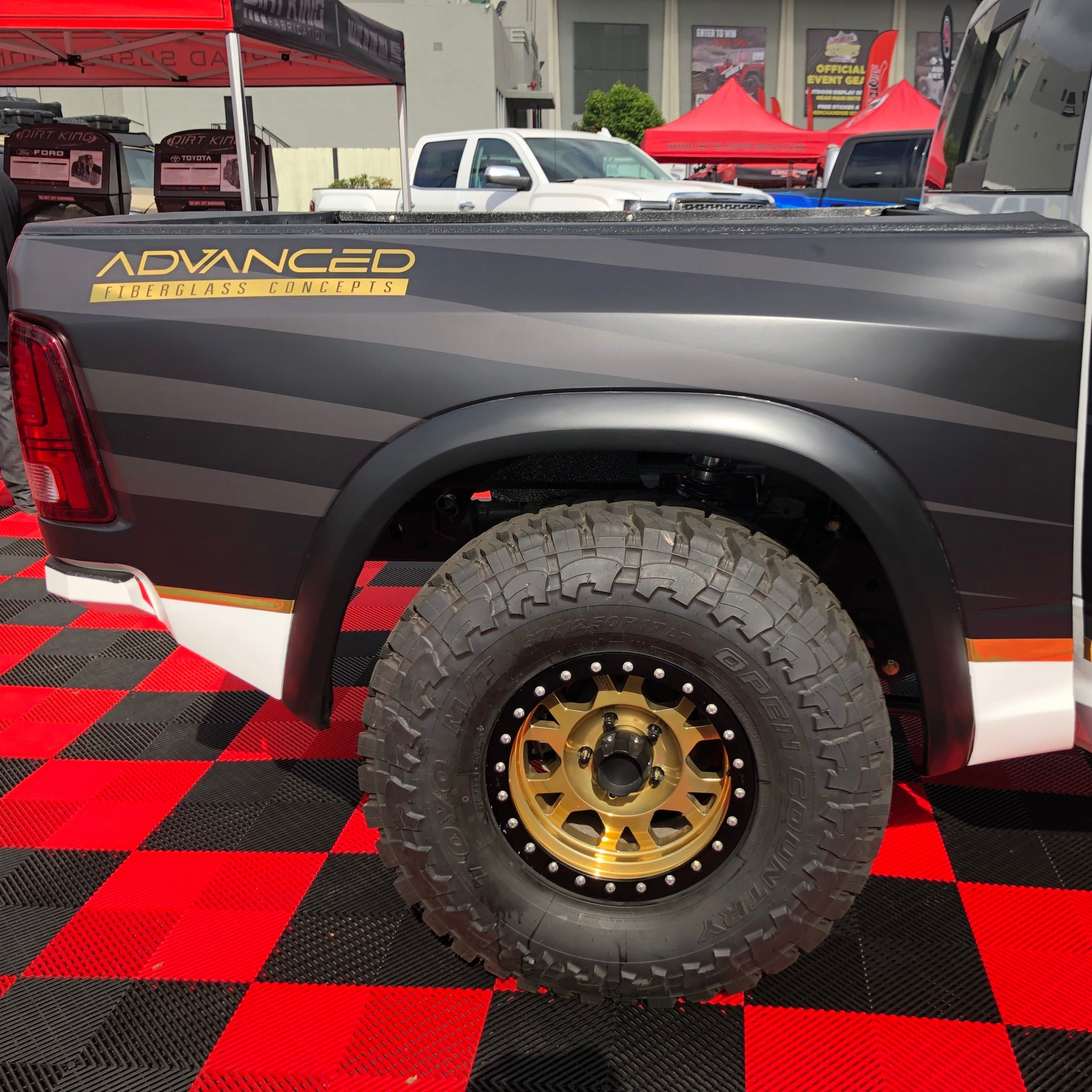 2009-2018 Dodge Ram TRX Kit showcasing a modified truck bed with rugged tires and custom wheel design.