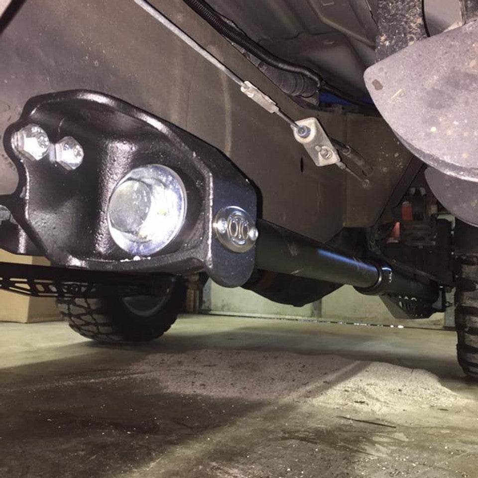 Beside frame traction bar mounts installed under a vehicle, showcasing robust construction and mounting points for enhanced stability.