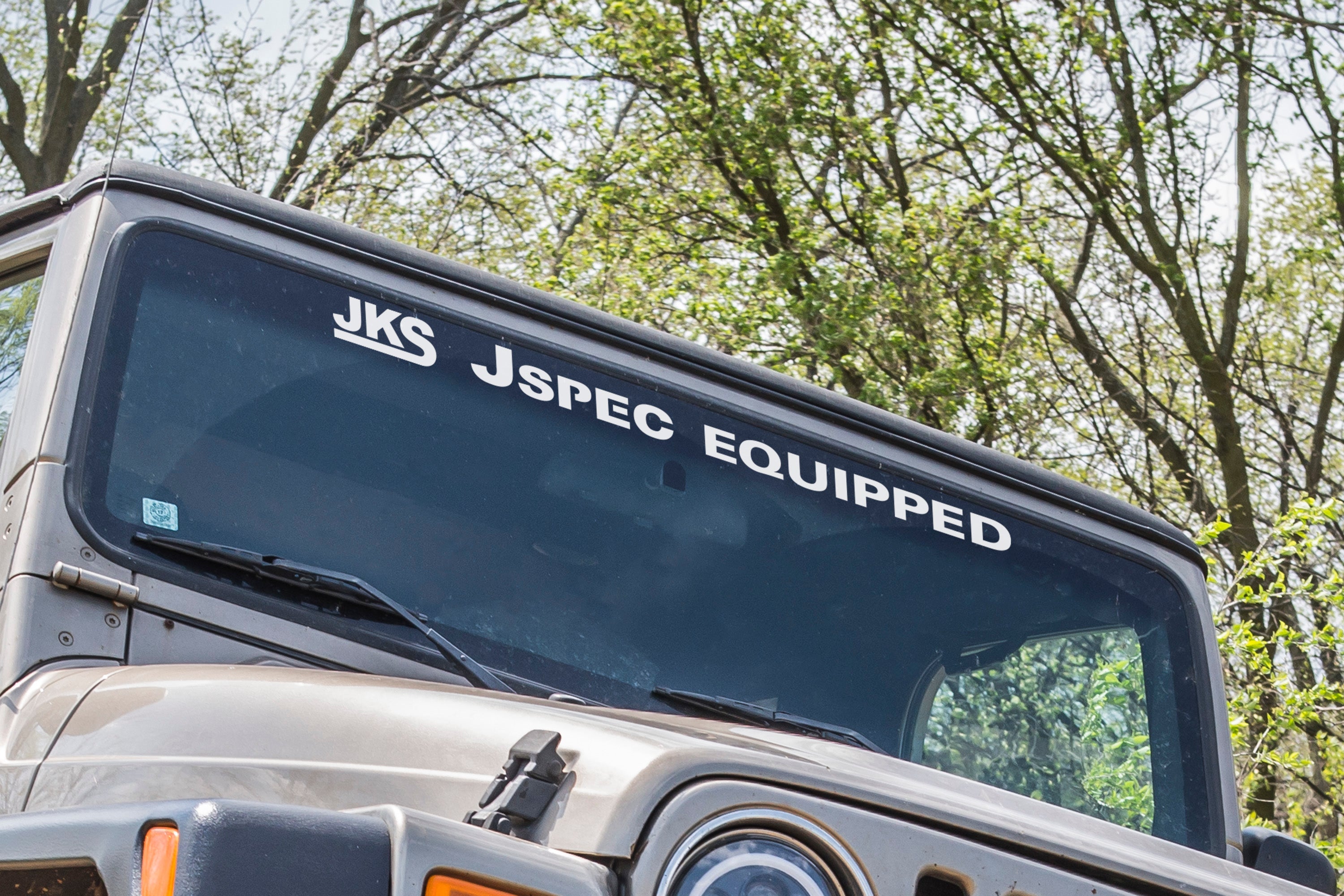 36-inch windshield decal reading "Jspec Equipped" displayed on a vehicle, showcasing offroad style and customization.