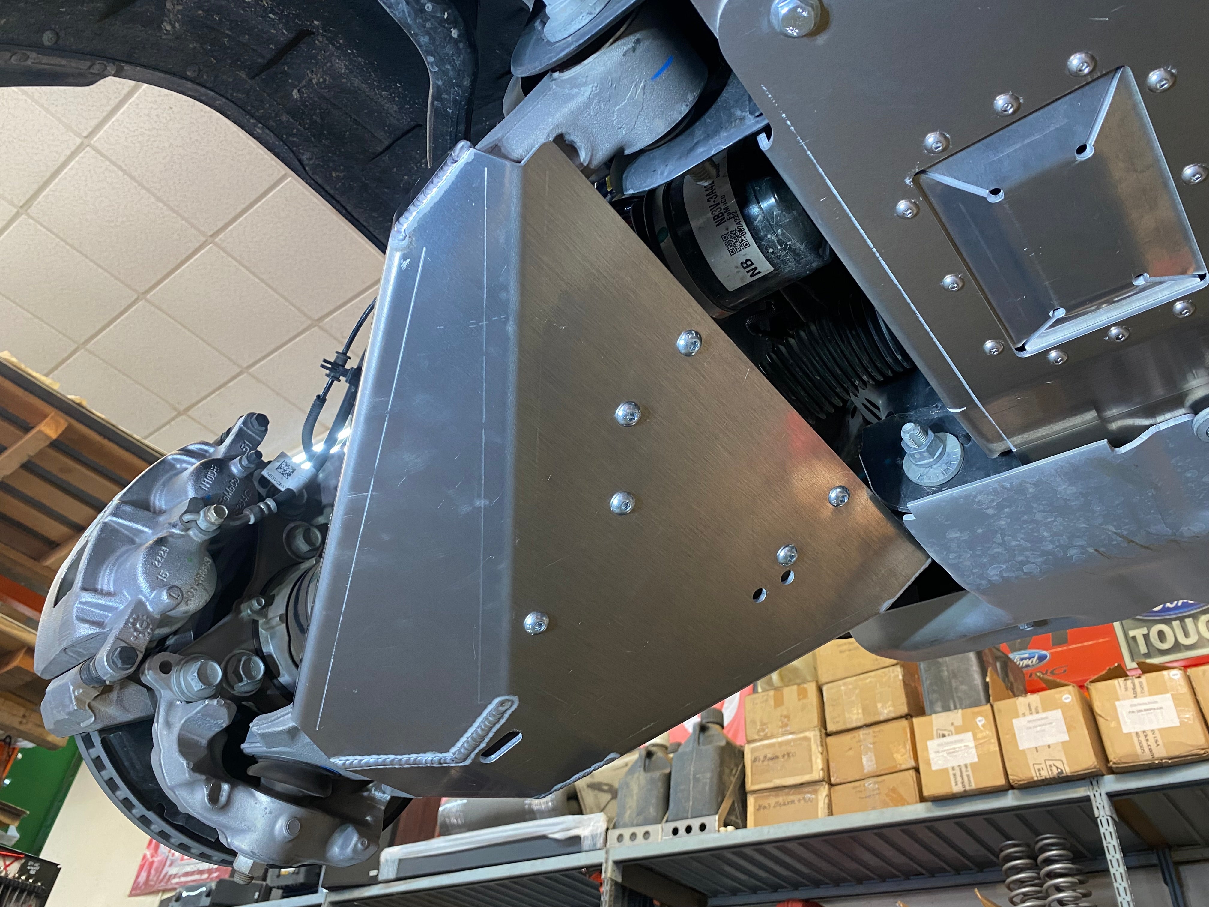 Bronco Raptor 2022 lower control arm skid plate kit installed, showcasing durable protection for offroad performance.