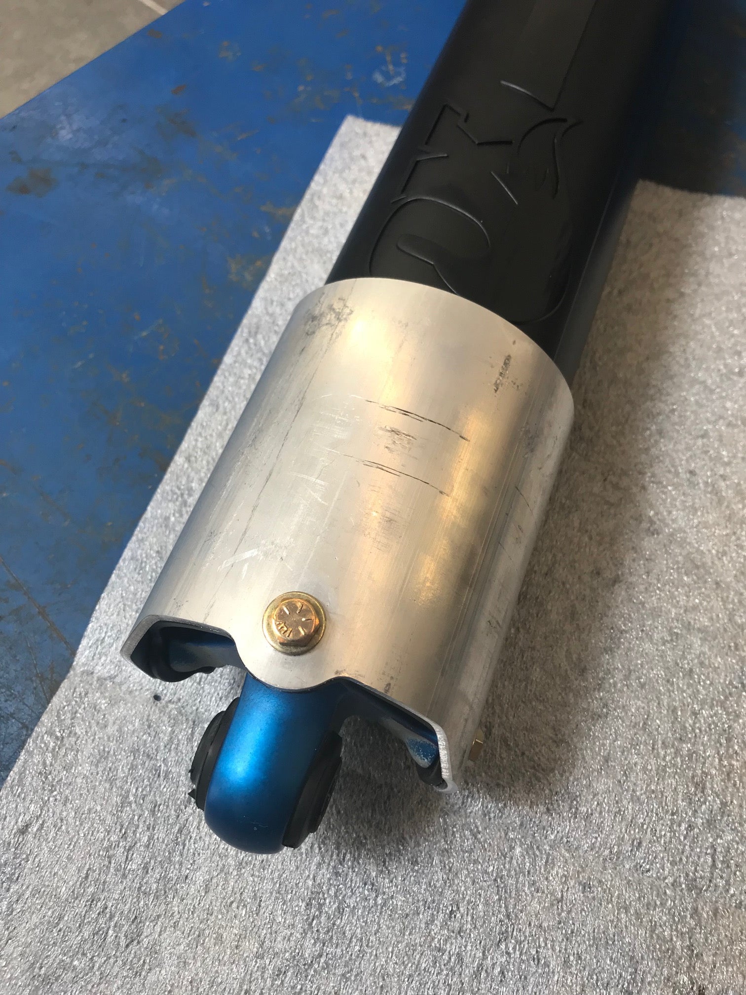 Rear shock guard for 2017-2024 Ford Raptor, featuring a sleek design with aluminum and blue accents for protection.