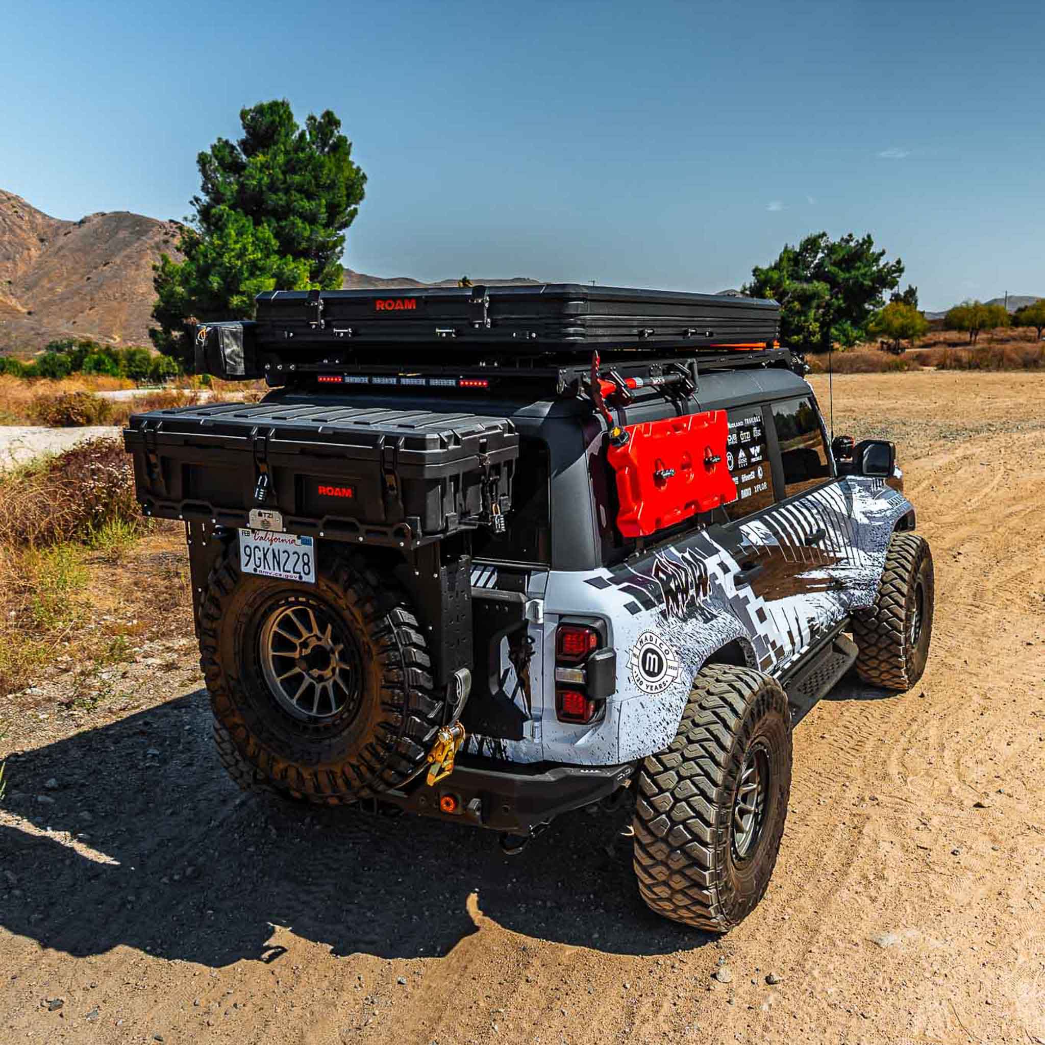 2022-2025 Ford Bronco Raptor Rear Quarter Kit installed on a modified SUV with offroad gear in a rugged outdoor setting.