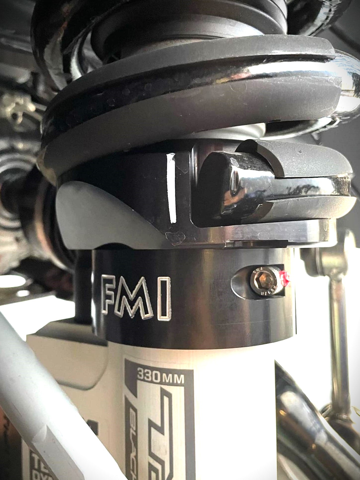 Close-up of the 2025 Ram RHO 2.5 inch front leveling kit showcasing the shock mount and adjustment features.