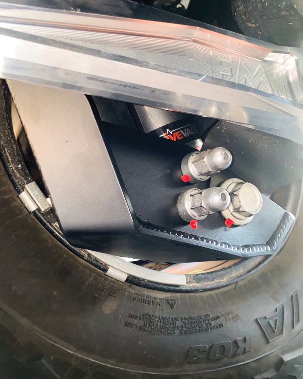 2024 Ranger Raptor rear shock skid kit showcasing durable metal construction and secure fittings near the tire.