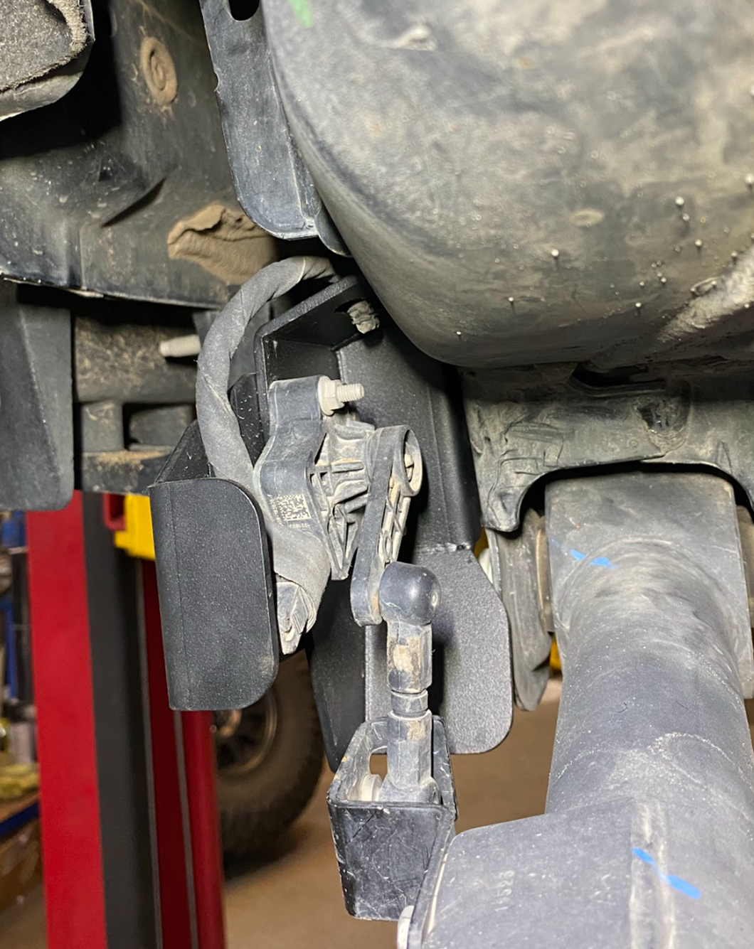 Rear suspension travel sensor wire protector for 2024 Ranger Raptor, enhancing durability and protection of wiring components.