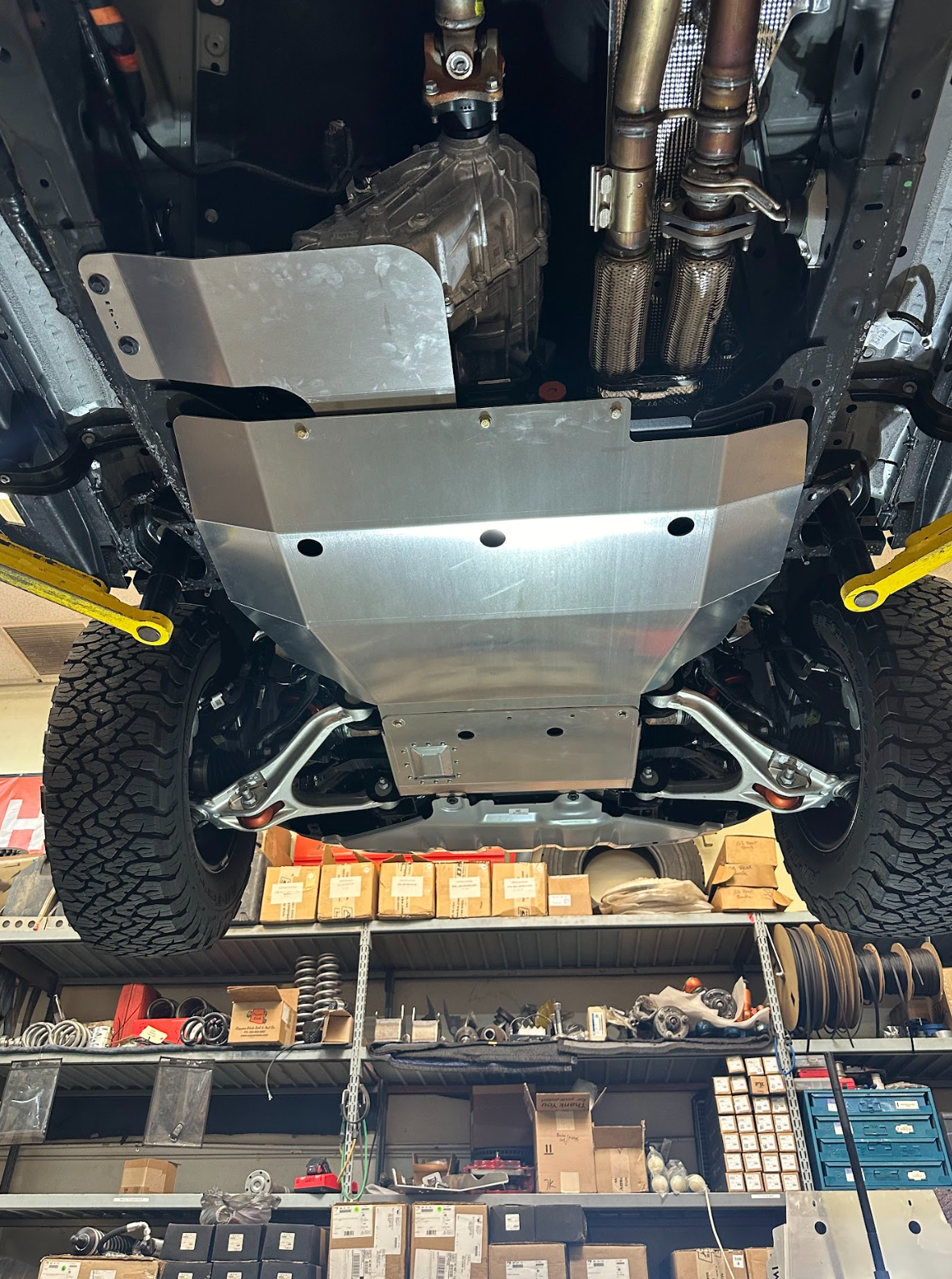 2024 Ford Ranger Raptor skid plate installed, showcasing durable protection under the vehicle in a workshop setting.