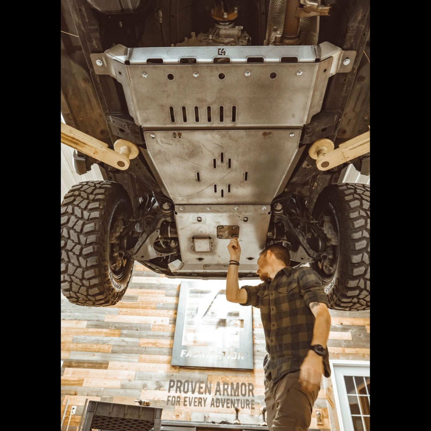 Full skid plates for 2010+ 4Runner, showcasing undercarriage protection during installation in an offroad shop.