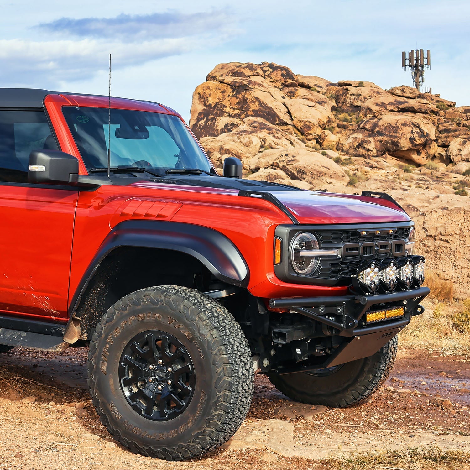 2021 Ford Bronco Baja bumper with off-road lights, showcasing rugged design and enhanced front protection in a desert setting.