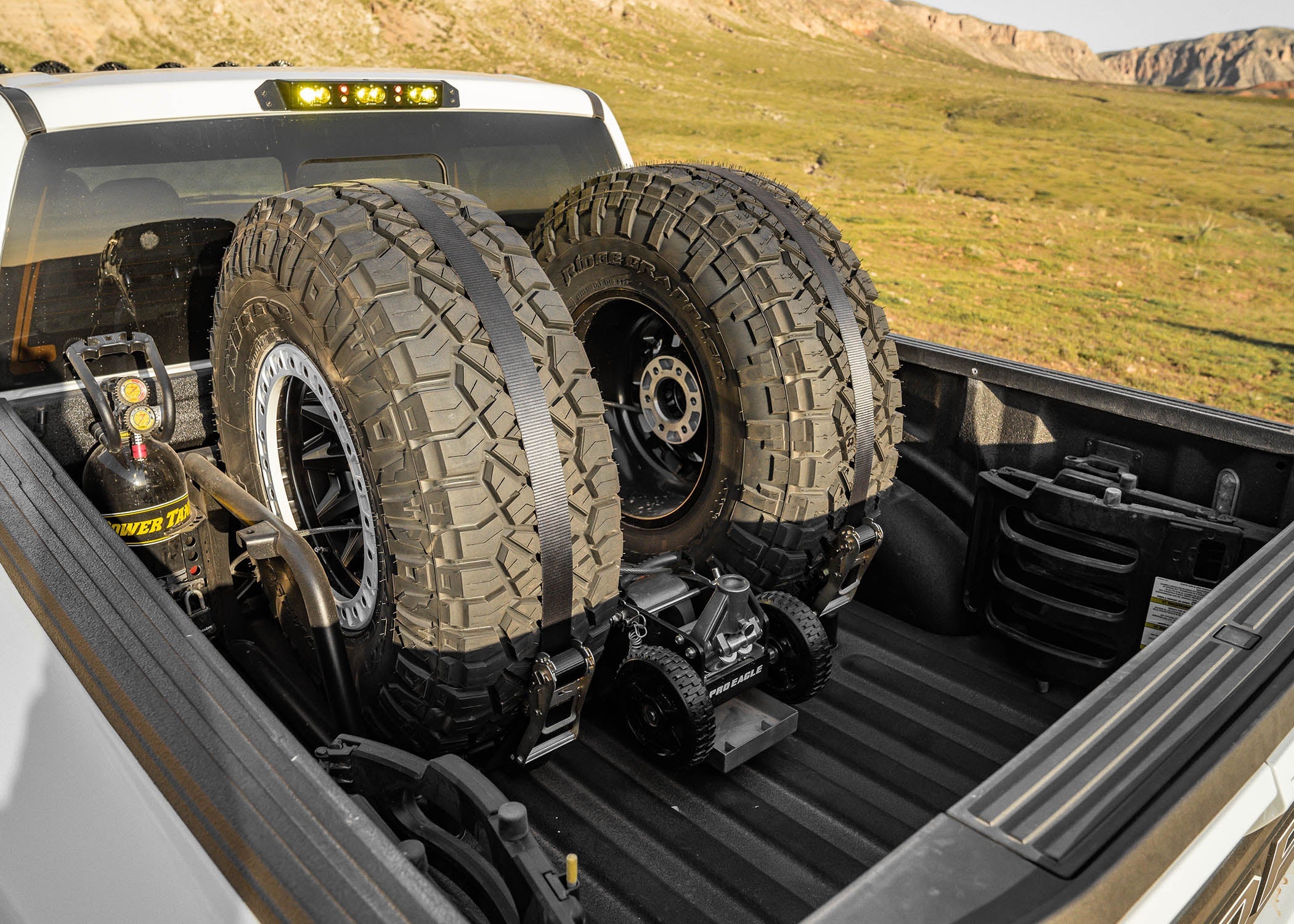 2017-2023 SVCOFFROAD Raptor Chase Rack with two mounted spare tires in a truck bed, showcasing offroad readiness.