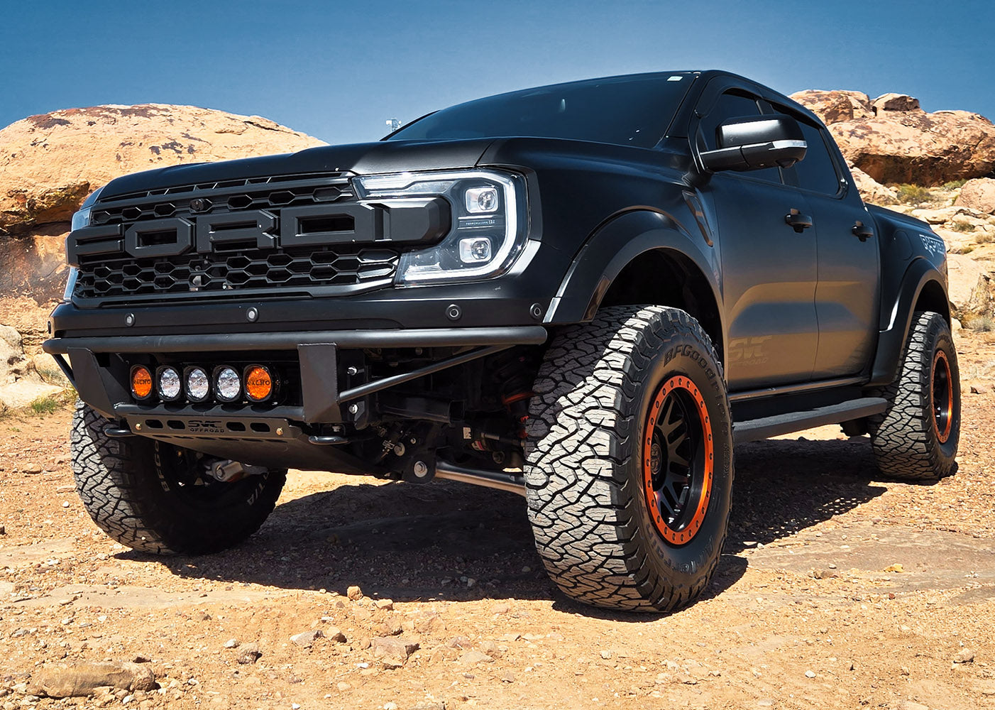 2024 Ranger Raptor Baja Flush Front Bumper installed on a rugged black truck, showcasing offroad capabilities and style.
