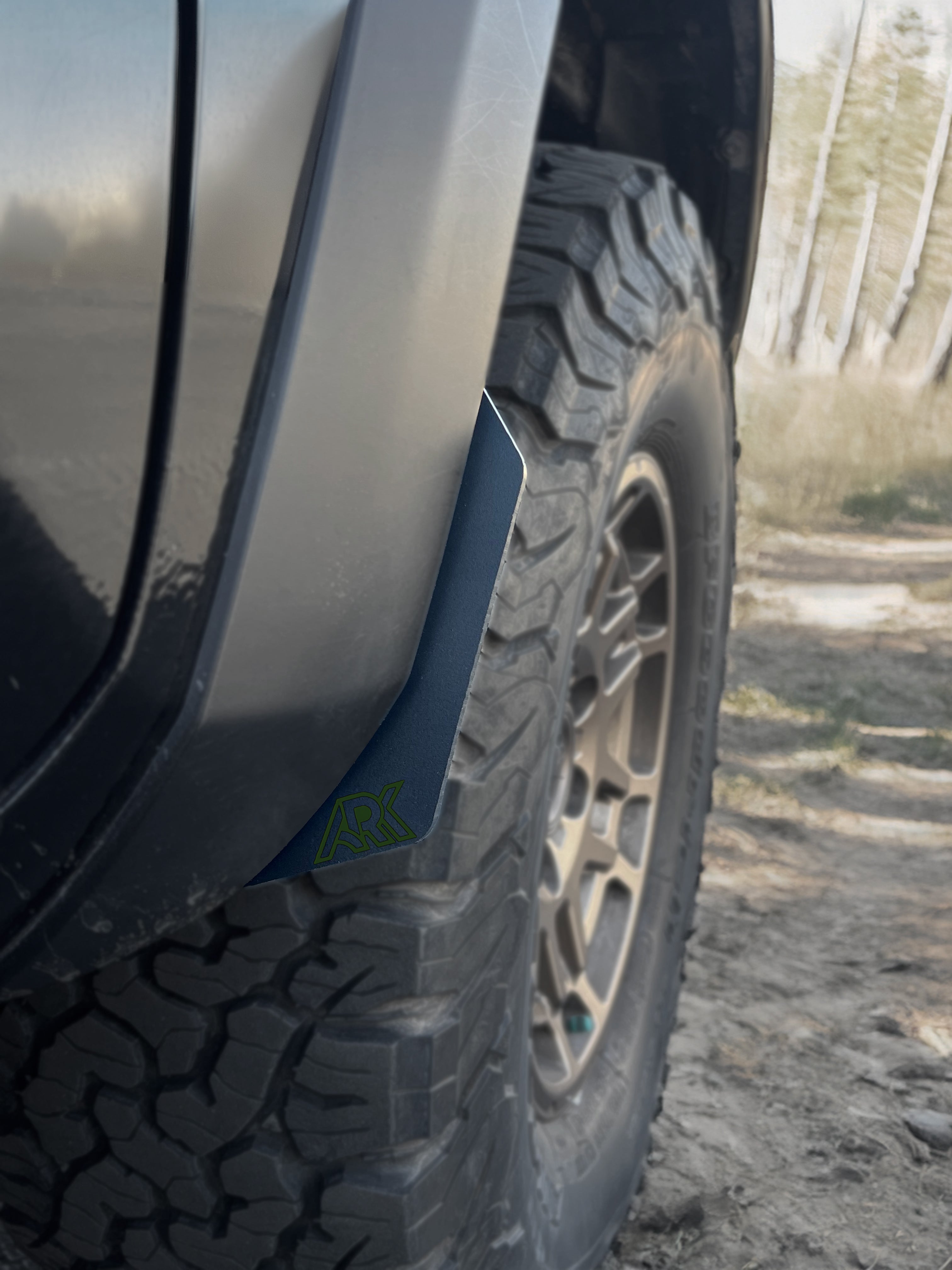 TriXpoly splash guards and mudflaps installed on a 2016-2023 Toyota Tacoma, enhancing off-road protection and style.