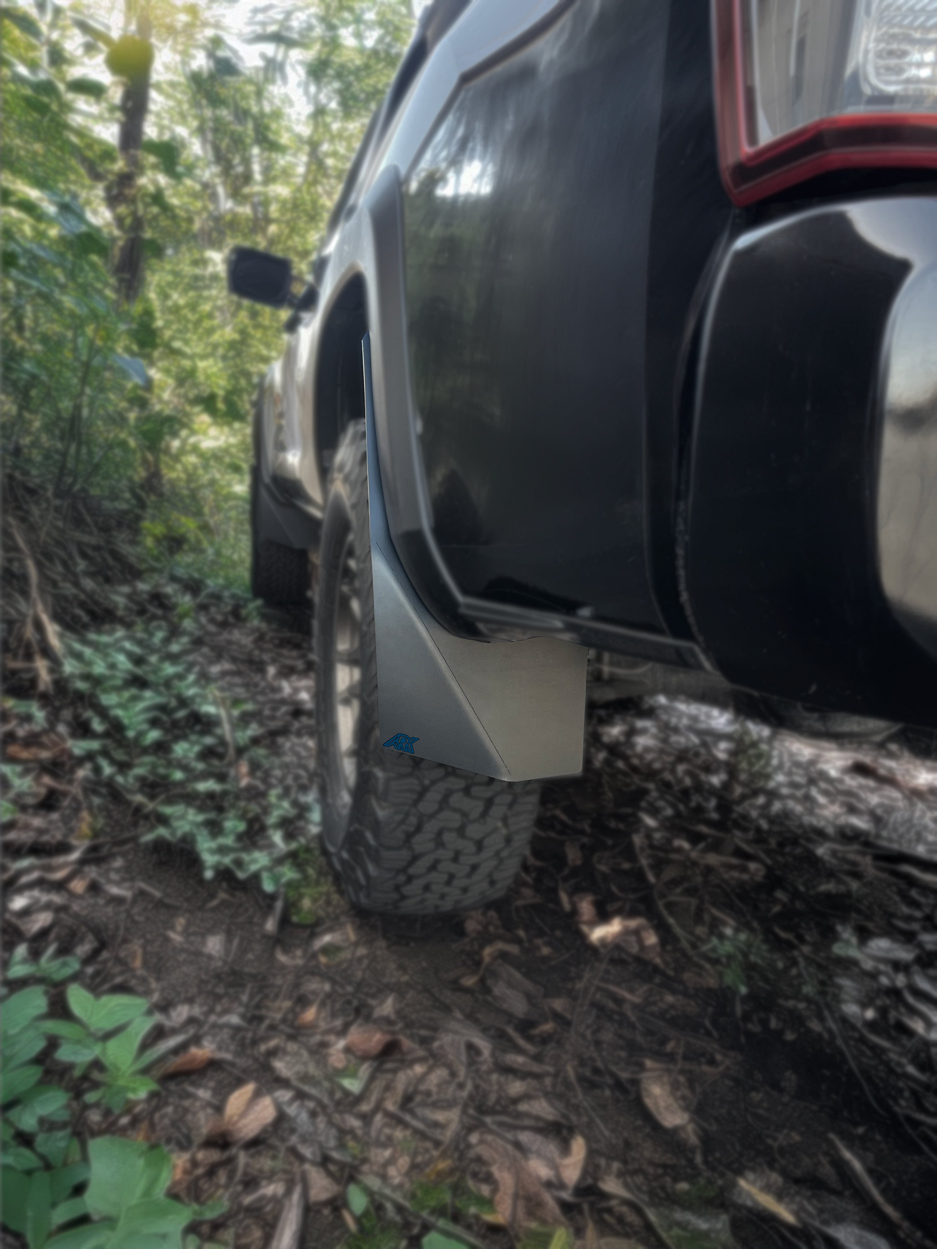 TriXpoly mudflaps for 2016-2023 Toyota Tacoma, designed for off-road protection and durability. Ideal for rugged terrain.