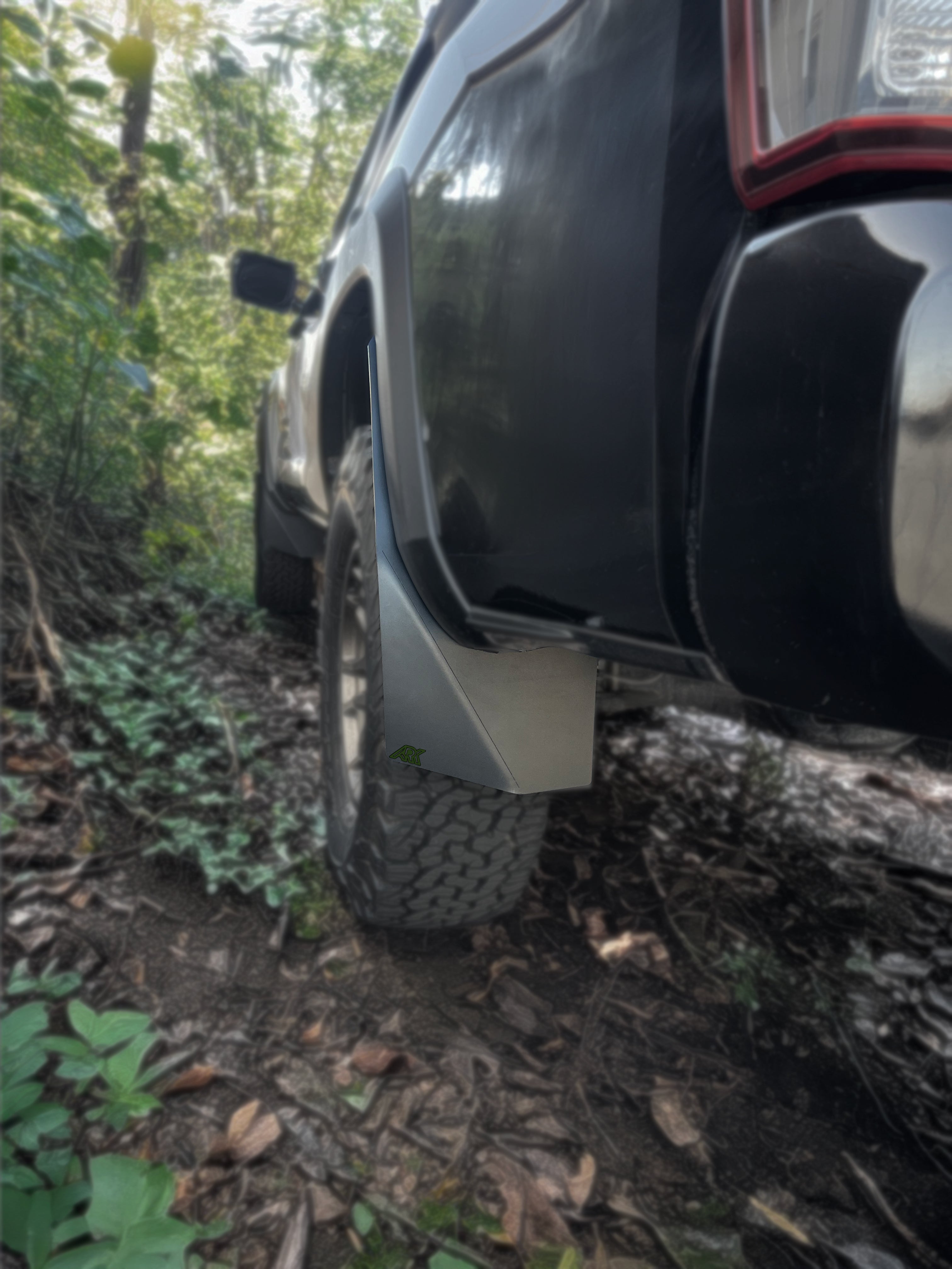 TriXpoly mudflaps installed on a 2016-2023 Toyota Tacoma, providing protection and durability for offroad adventures.