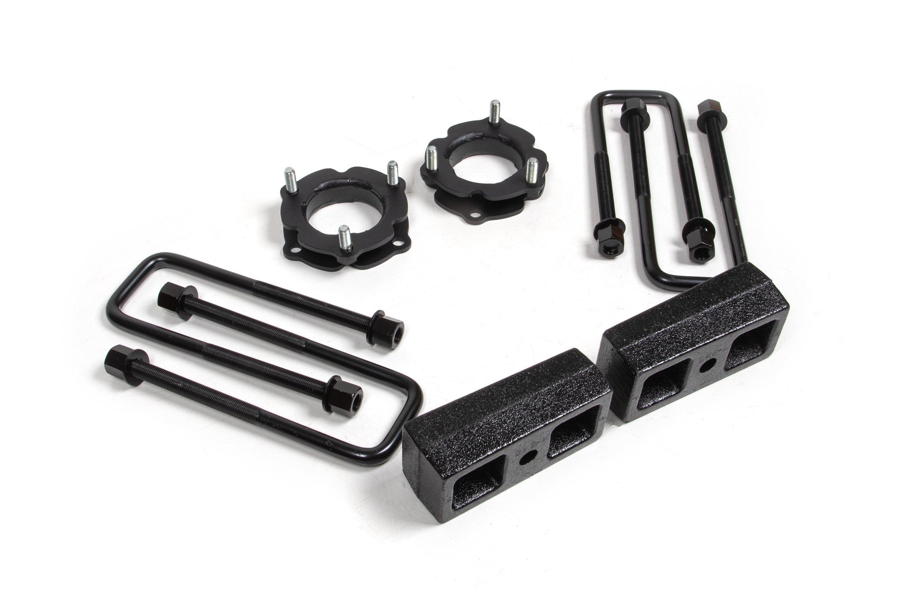 2.5 inch lift kit components for Toyota Tacoma 4WD, including spacers, brackets, and hardware for enhanced off-road performance.