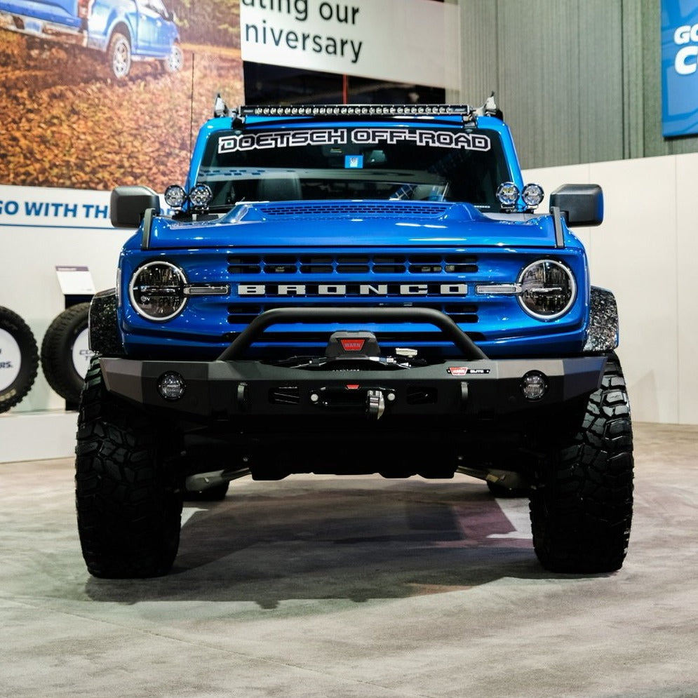 2021-2024 Ford Bronco with Sasquatch Flares showcasing a bold blue exterior and off-road accessories at an event.