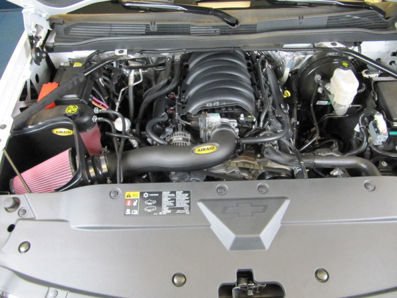 Airaid MXP intake system installed in a 2014 GM 1500 Pickup engine bay, featuring a red air filter and intake tube.