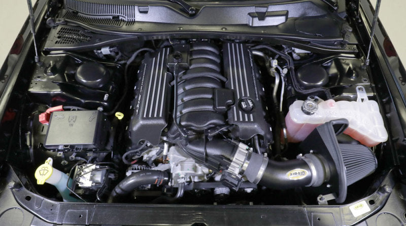 Airaid cold air intake kit installed in a Dodge Challenger V8 engine bay, enhancing performance and airflow.