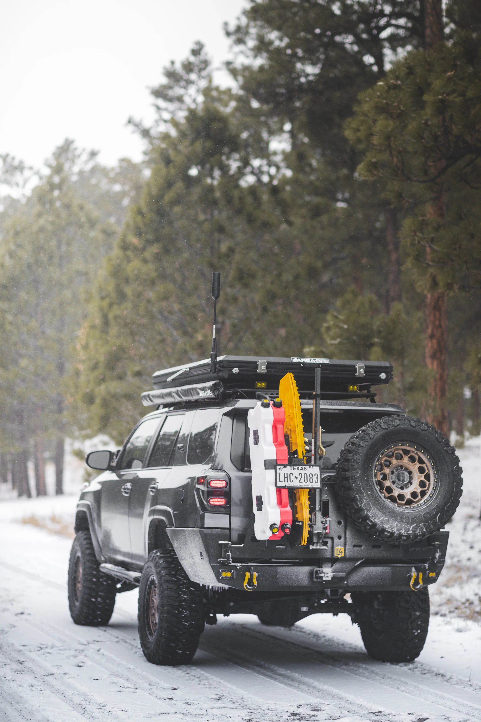 C4 4Runner Overland Series rear bumper installed on a 5th Gen 4Runner, showcasing offroad features in a snowy landscape.