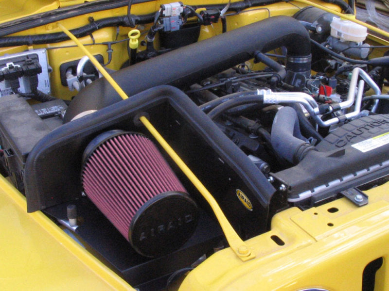 Airaid CAD intake system with red filter installed in a 97-06 Jeep Wrangler TJ 4.0L engine bay for improved performance.