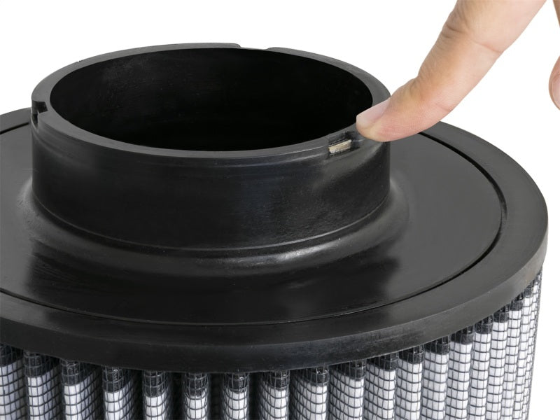 aFe MagnumFLOW air filter with a textured surface and a finger pointing at the inlet, showcasing its design and quality.