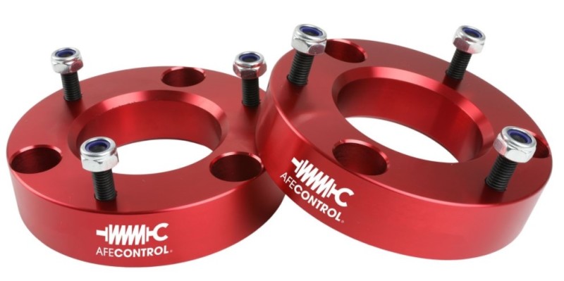 aFe CONTROL 2.0 IN Leveling Kit for 2007-2021 GM 1500, featuring red aluminum spacers and hardware for enhanced vehicle stance.