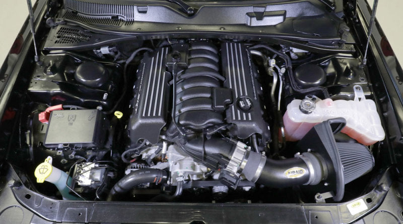 Airaid cold air intake kit installed in a Dodge Challenger V8 engine bay, enhancing performance and airflow.