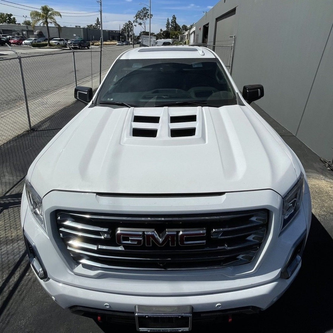 2019-2021 GMC Sierra hood featuring a sleek design and dual vents, ideal for enhancing vehicle performance and style.
