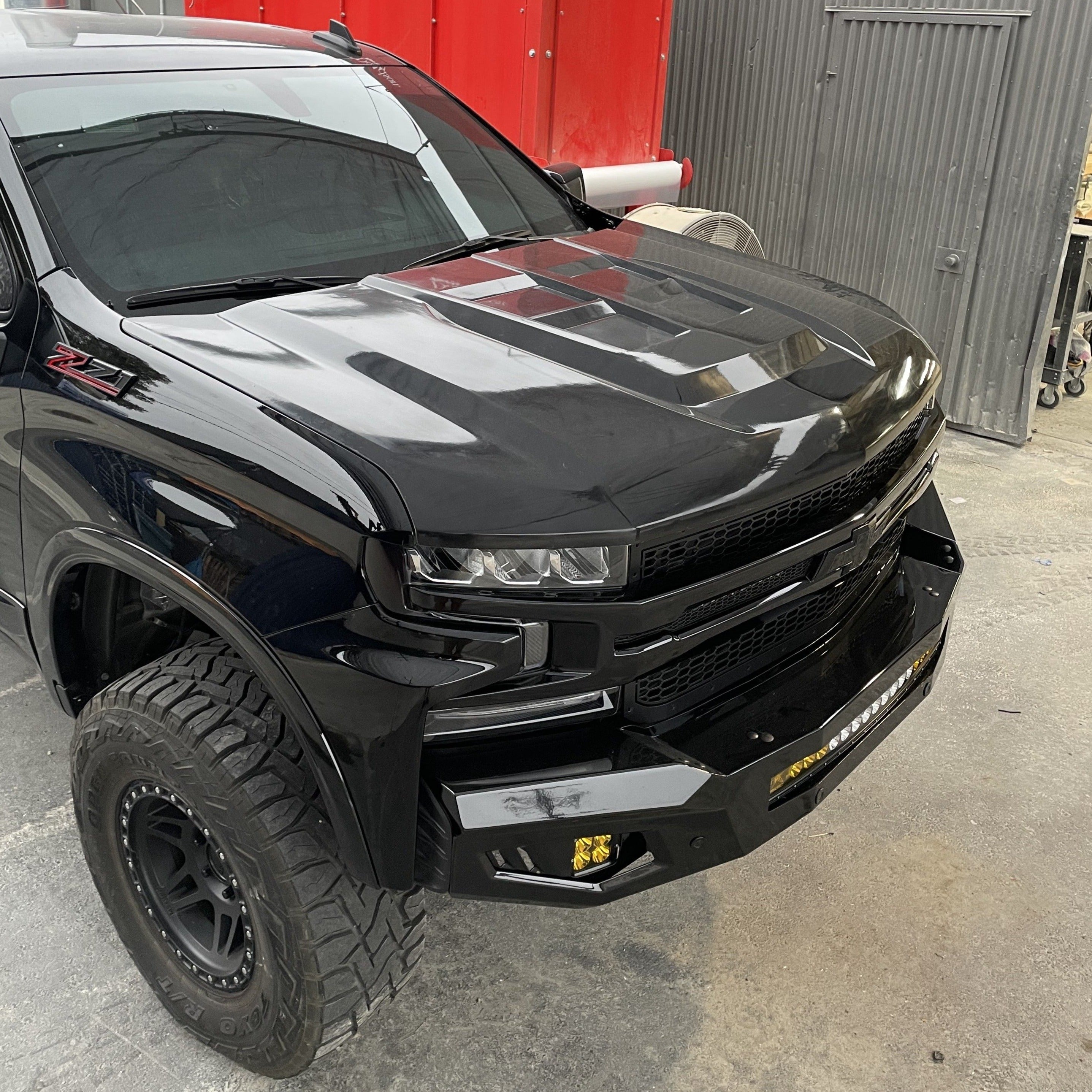 2019-2021 Chevrolet Silverado hood showcasing a sleek black finish and aggressive design, ideal for offroad enthusiasts.