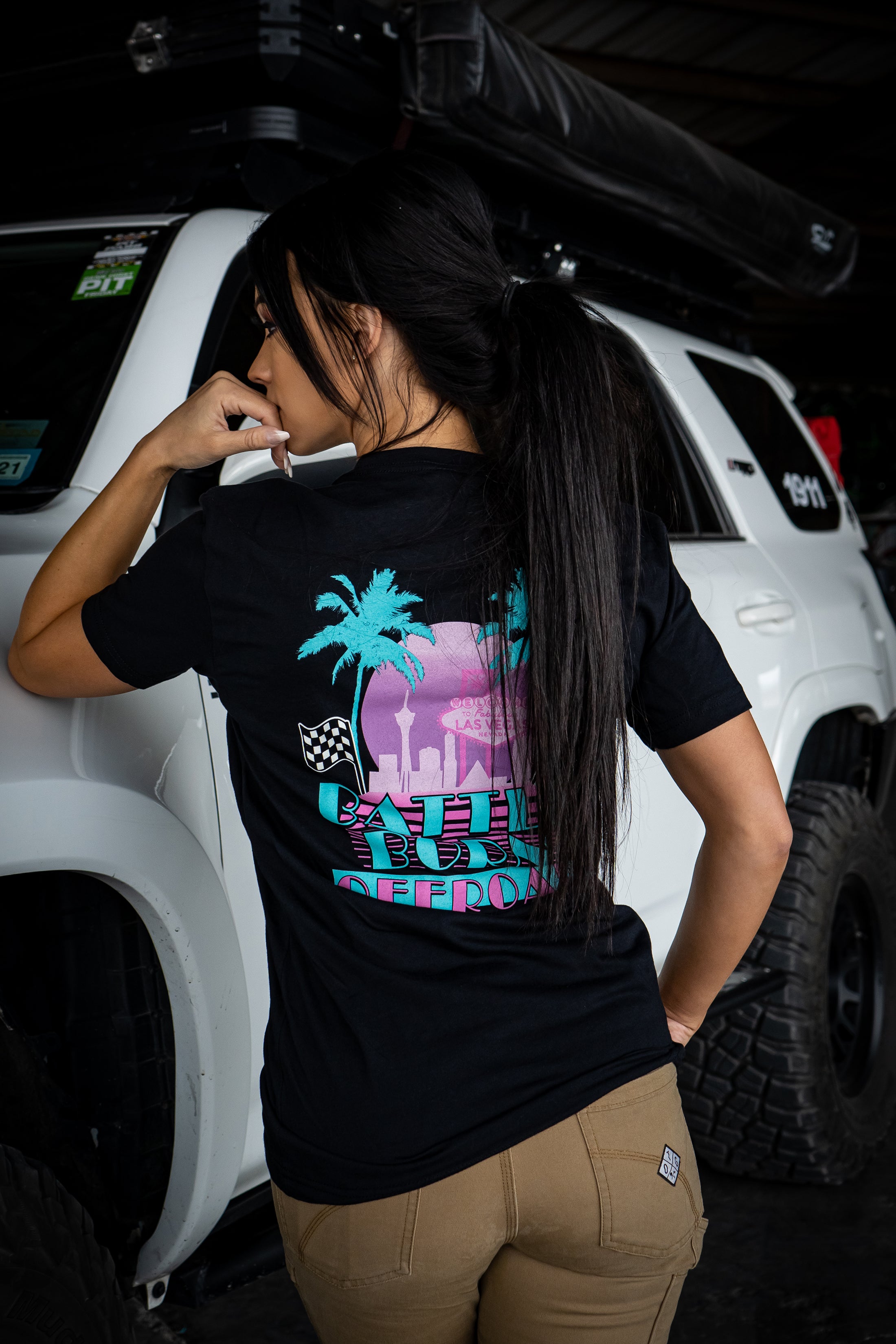 BBO Miami Vice T-Shirt featuring vibrant palm tree graphics and logo on a black background, worn by a model.