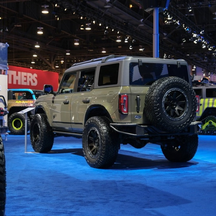 2021-2022 Ford Bronco 4-Door Rear Quarter Kit displayed on a modified Bronco with offroad tires at an automotive show.