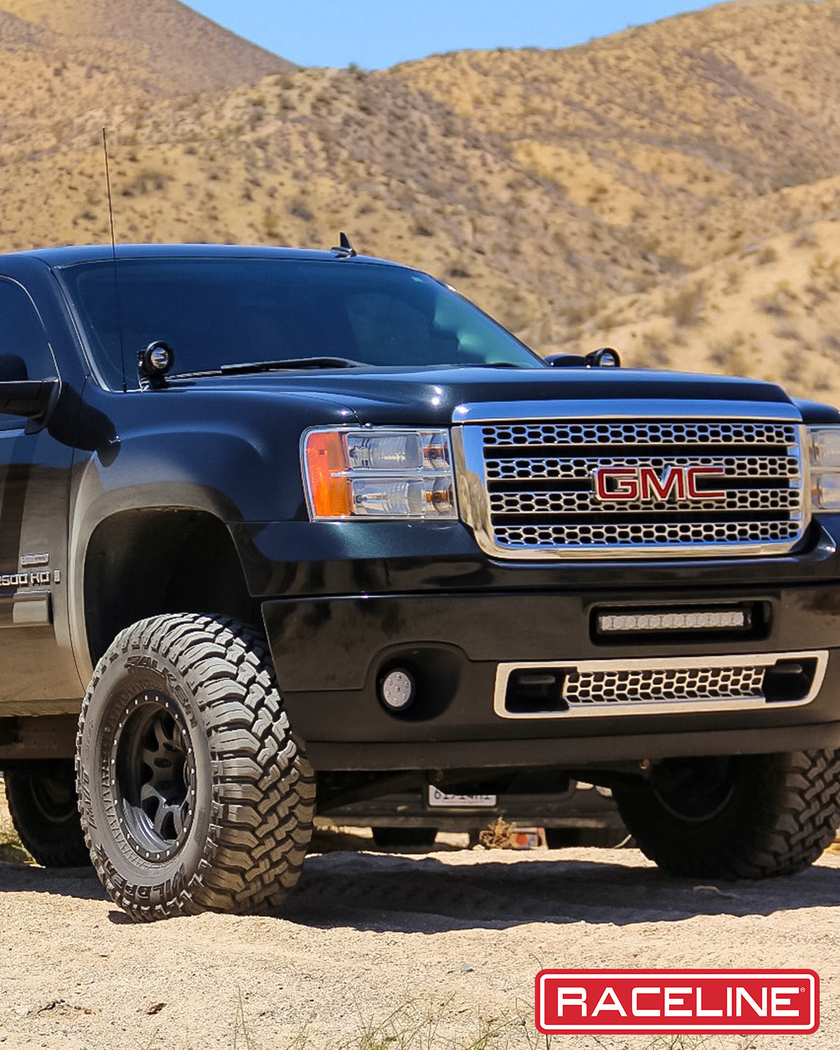 Black GMC truck featuring 929B Avenger wheels, showcasing rugged off-road capabilities in a desert landscape.