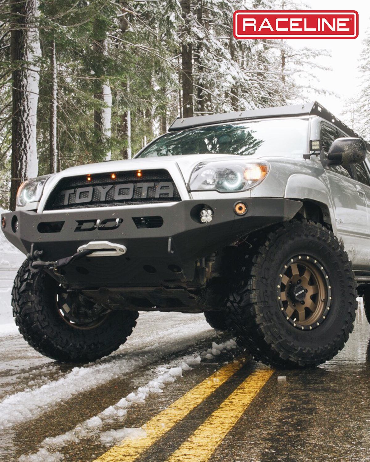 Offroad-ready Toyota 4Runner equipped with a 935BZ Defender bumper, showcasing rugged design in a snowy forest setting.