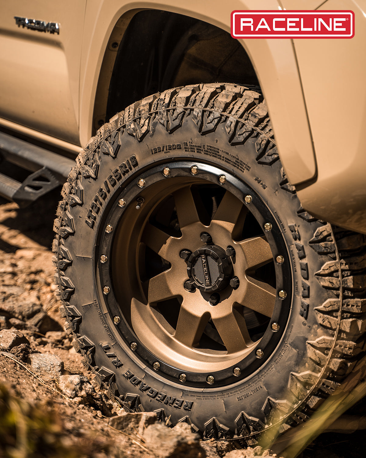 Close-up of the 935BZ Defender wheel mounted on an offroad vehicle, showcasing rugged tire tread and stylish design.
