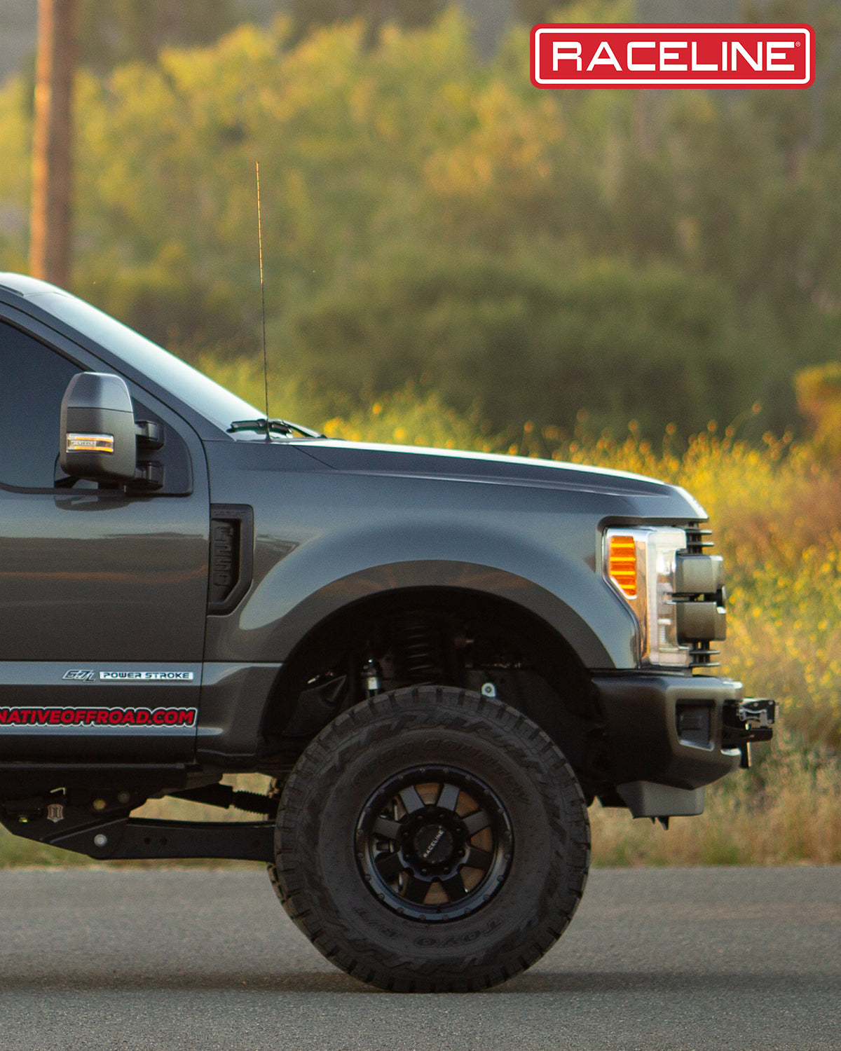 Side view of a lifted truck featuring the 935B Defender wheels, showcasing rugged offroad capabilities.