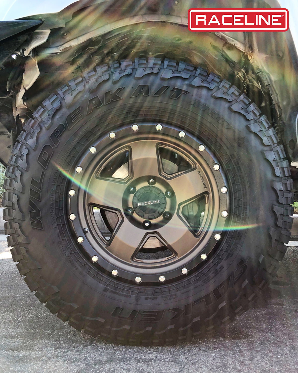 Raceline 937BZ Combat wheel mounted on an all-terrain tire, showcasing rugged design for off-road performance.