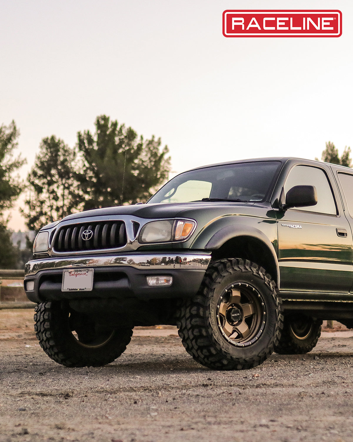 Toyota Tacoma equipped with Raceline 937BZ Combat wheels, showcasing a rugged off-road look in a natural setting.