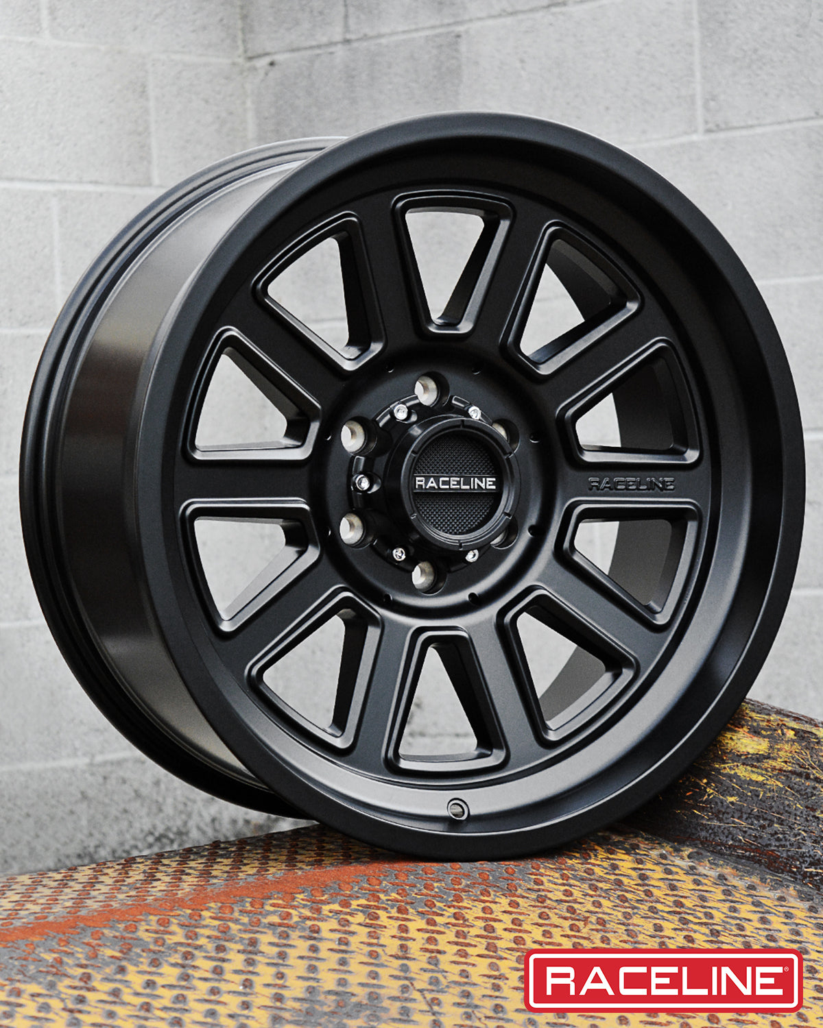 Black 943B Magnum wheel by Raceline, featuring a sleek design with multiple spokes and a matte finish, displayed on a textured surface.