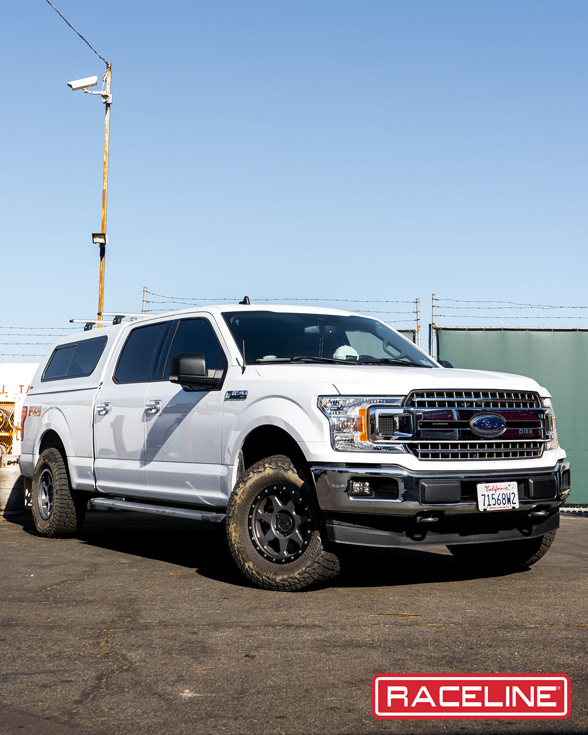 Ford F-150 with Raceline 949G 7X wheels, showcasing an off-road setup in a rugged outdoor setting.