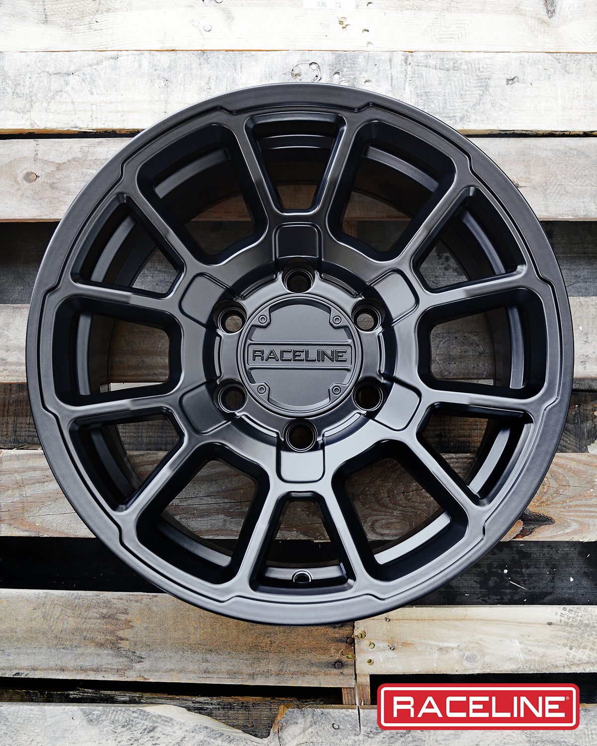 Black 950B Gauge wheel with a multi-spoke design, showcasing a sleek finish against a wooden background.