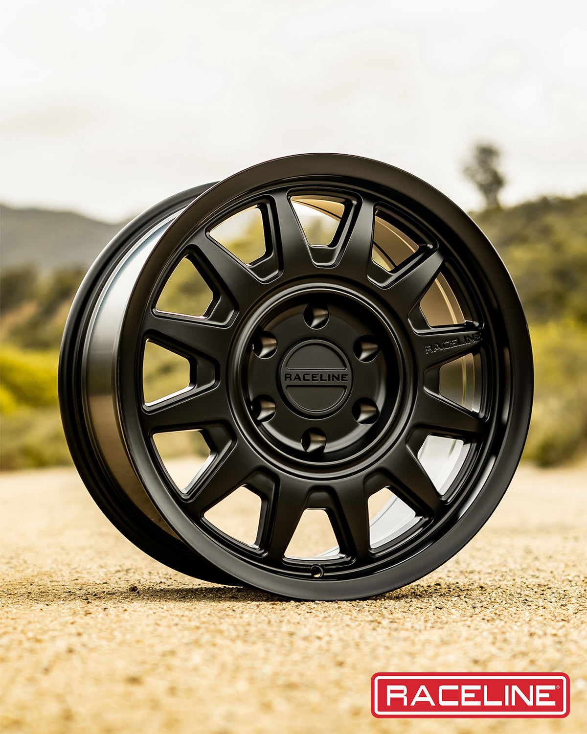 Black Raceline 952B Aero HD wheel displayed on a dirt road, showcasing its rugged design and off-road capability.